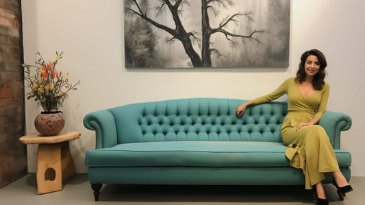 Woman sitting on a teal couch in a nice room