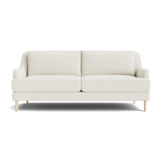 The Kaydan Sofa is a modern, cream-colored piece featuring two cushions and light wooden legs, elegantly displayed against a white background. Its minimalist design showcases smooth lines and offers a cozy appearance.