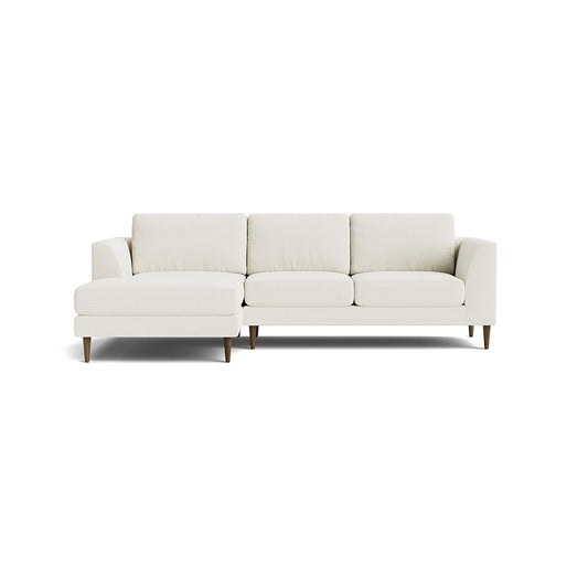 The Dekayess Chaise 98" Sectional is a modern piece in light beige, featuring a left-facing chaise and three seat cushions. It boasts straight armrests and wooden legs, all set against a white background.