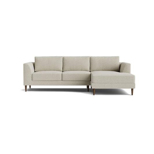 The Dekayess Chaise 98" Sectional is a light gray sofa featuring three seat cushions and a right-side extended chaise. It showcases a modern, minimalist design with clean lines and wooden legs, set against a plain white background.