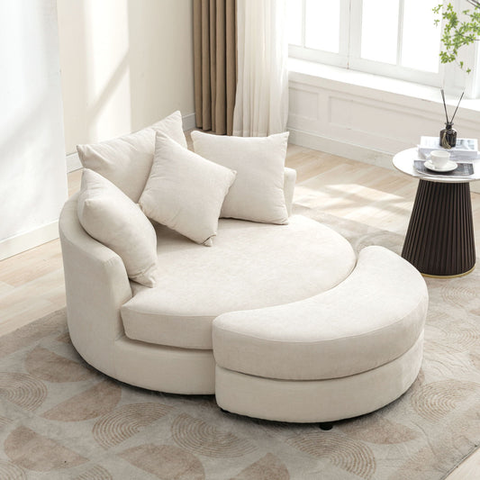 A beige 360° swivel accent barrel chair with storage ottoman and four matching pillows sits in a bright room. Nearby, a small round table holds a coffee cup and saucer on a geometric-patterned rug, with curtains by the window.