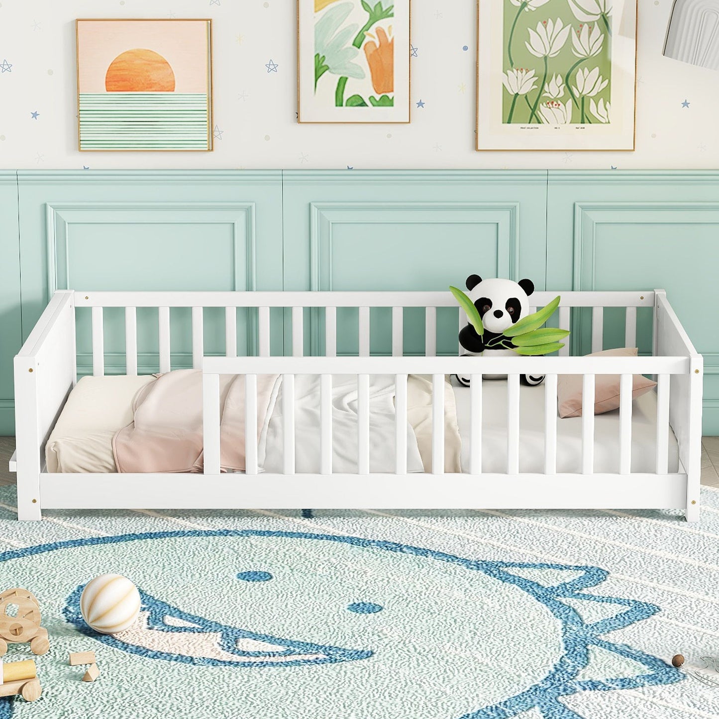 A white floor platform bed with built-in book storage and a panda plush toy holding leaves sits against mint green paneled walls. Framed nature-themed art adorns the room, while a blue and white whale-design rug covers the floor, surrounded by toys.