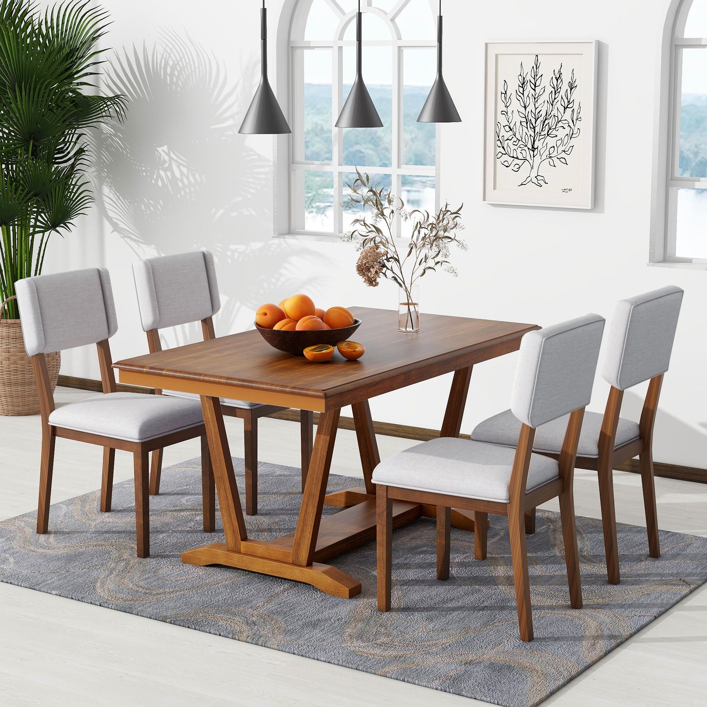 In the dining room, the Topmax 5 Piece Rustic Dining Table Set with four upholstered chairs takes center stage, accented by a gray patterned rug. A bowl of oranges and a vase with dried flowers adorn the table. Black pendant lights illuminate from above, while arched windows and a corner plant enhance the ambiance.