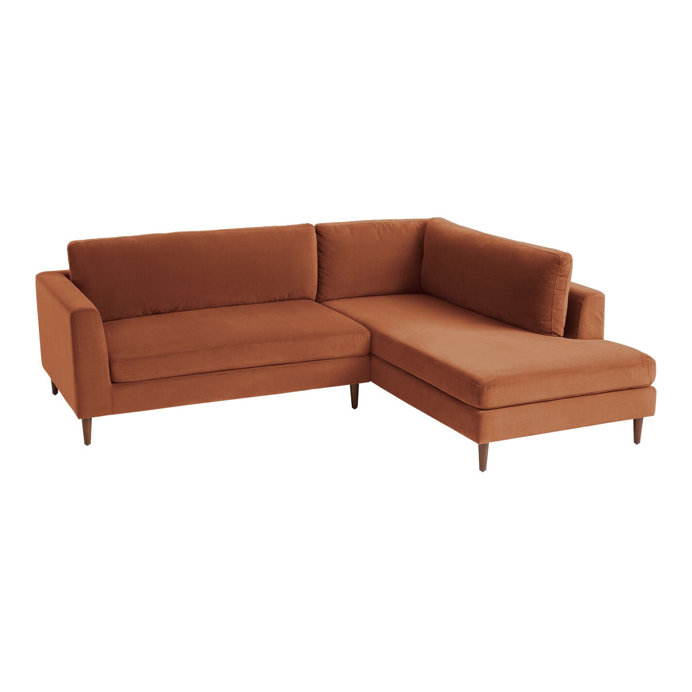 The Camile Velvet Right-Facing Sectional Sofa is a brown L-shaped piece that boasts clean lines and a mid-century modern design, complete with tapered wooden legs and plush cushions. Its velvet fabric is soft and comfortable, making it a perfect fit for a contemporary living room.