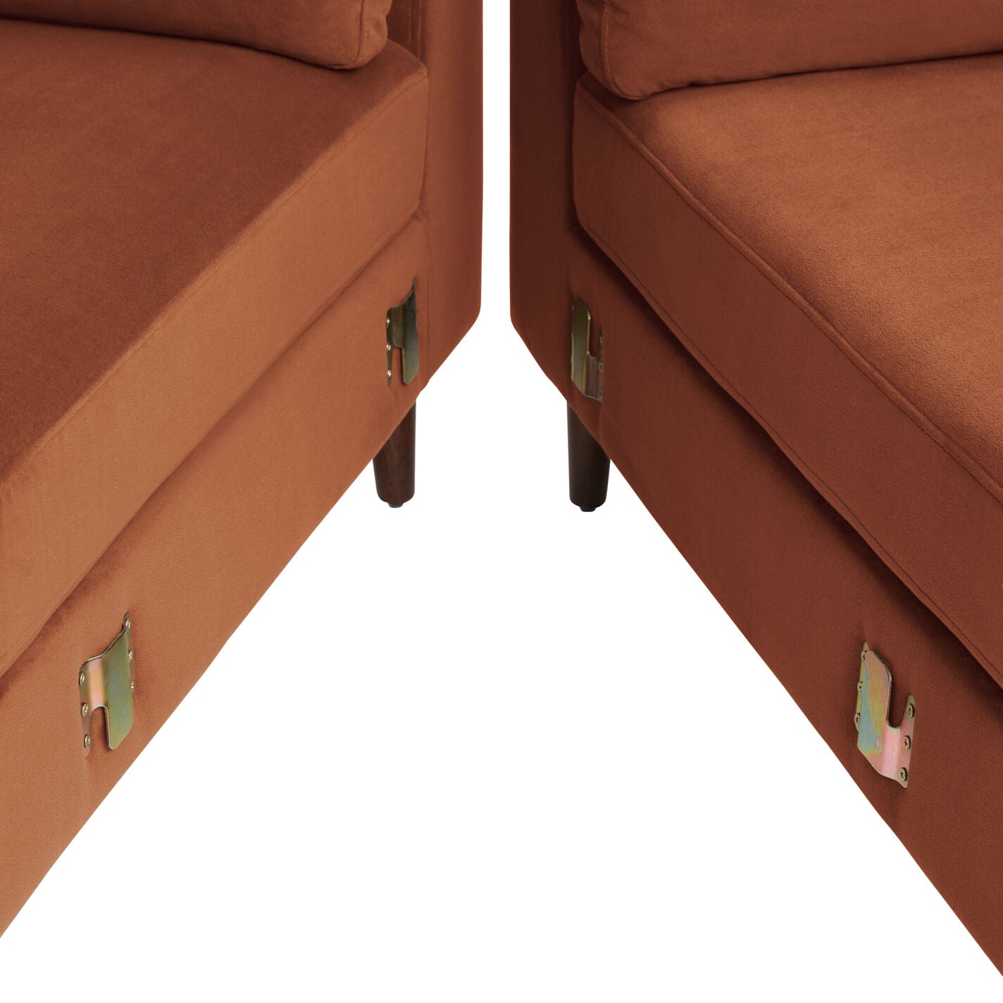 Close-up of two Camile Velvet Right-Facing Sectional Sofas, featuring metal connectors on the sides and arranged at an angle. The sofas are crafted with dark wooden legs and set against a plain white background.