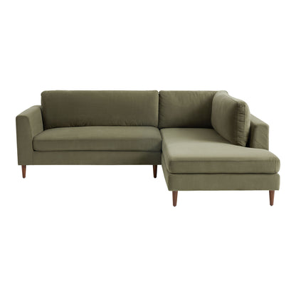 The Camile Velvet Right-Facing Sectional Sofa is a green L-shaped piece with wooden legs. It features a left armrest on the longer section and a right armrest on the shorter section, which concludes with a chaise lounge for additional seating or relaxation.