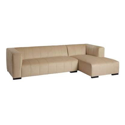 The Cambrie Wheat Velvet Right-Facing Sectional Sofa boasts a modern beige finish, complete with a chaise lounge on the right. It features a sleek, minimalist design with blocky cushions set on black legs.