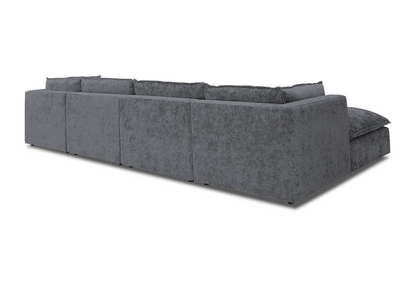 The Haine Modular Grand U-Sofa Sectional is a spacious, contemporary piece featuring textured grey fabric. It has a low profile with clean lines and is designed in an L-shape, set against a simple white backdrop when viewed from the back.