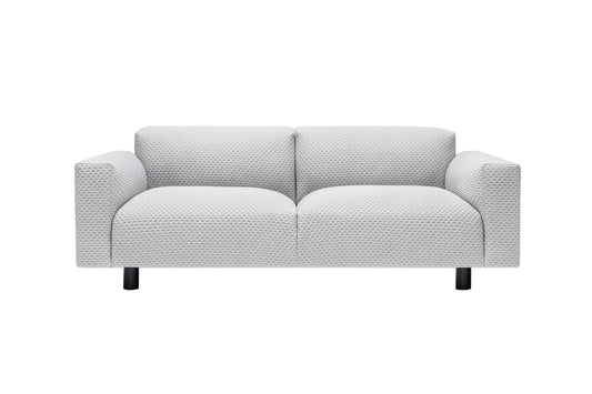 The Koti 2-seater Sofa is a contemporary loveseat in light gray with textured fabric and straight armrests, supported by four short black legs, against a plain white background.