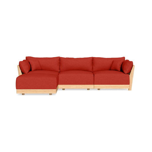 The Modular Bondi Latte 3 Seater Sectional is a contemporary L-shaped sofa featuring a sturdy wooden frame and vibrant red cushions. Designed for comfort, it comes with matching red pillows, making it perfect for a modern living space.