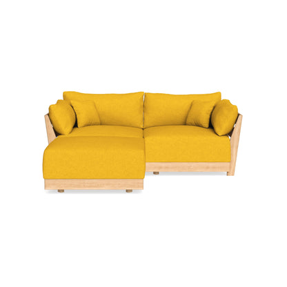 A modern yellow L-shaped sofa with a wooden frame, featuring plush cushions and a chaise lounge section, set against a plain white background.