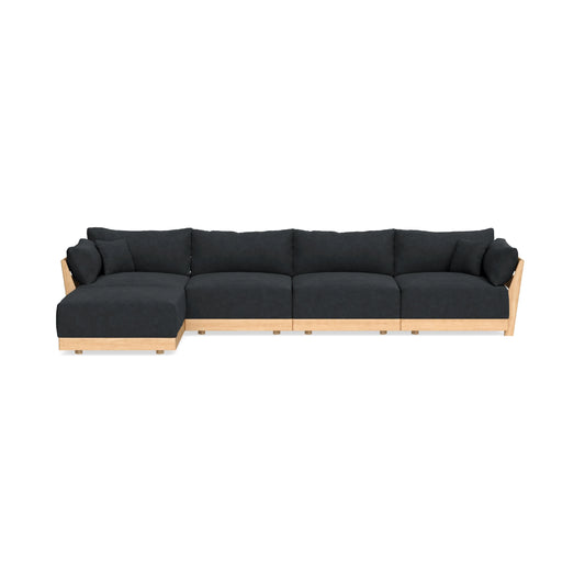 The Modular Bondi Latte 4 Seater Sectional is a contemporary L-shaped sofa featuring black cushions and a light wood base. It includes a chaise on the left side, providing generous seating space, set against a plain white background.