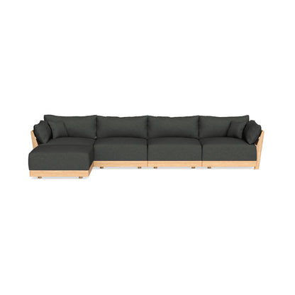 The Modular Bondi Latte 4 Seater Sectional is a contemporary and roomy L-shaped sofa, featuring dark green cushions and a light wooden frame, along with a left-side chaise lounge. It is showcased against a simple white backdrop.