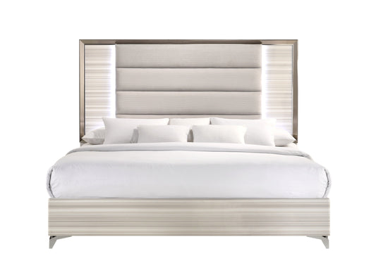 The Star bed features a tall, padded headboard upholstered in light gray fabric. Neatly made with a white comforter and pillows, it offers a clean, minimalist look. The frame has a light wood finish and includes an LED modern design.