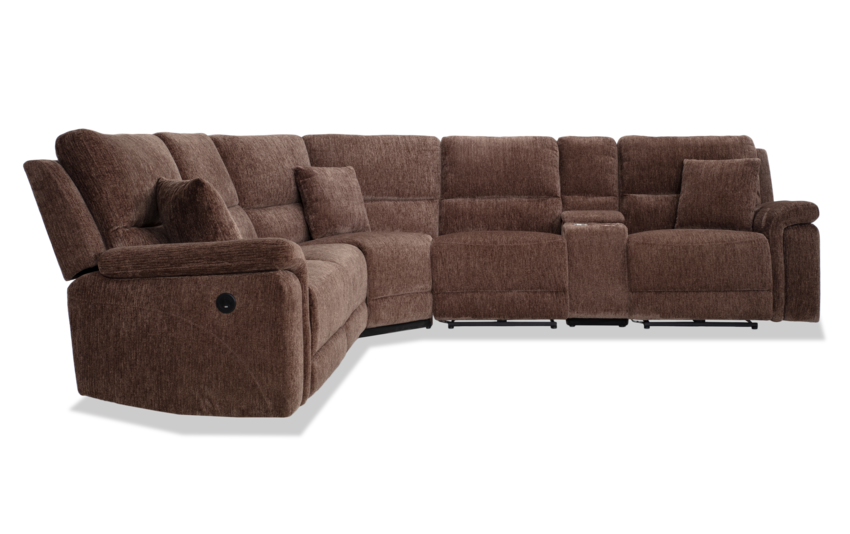 Introducing the Renegade Gray 125'' Power Reclining 6 Piece Sectional with USB Port: a spacious sectional sofa upholstered in textured gray fabric. It features cushioned seats and backs, multiple reclining sections, matching throw pillows, and a convenient built-in console.