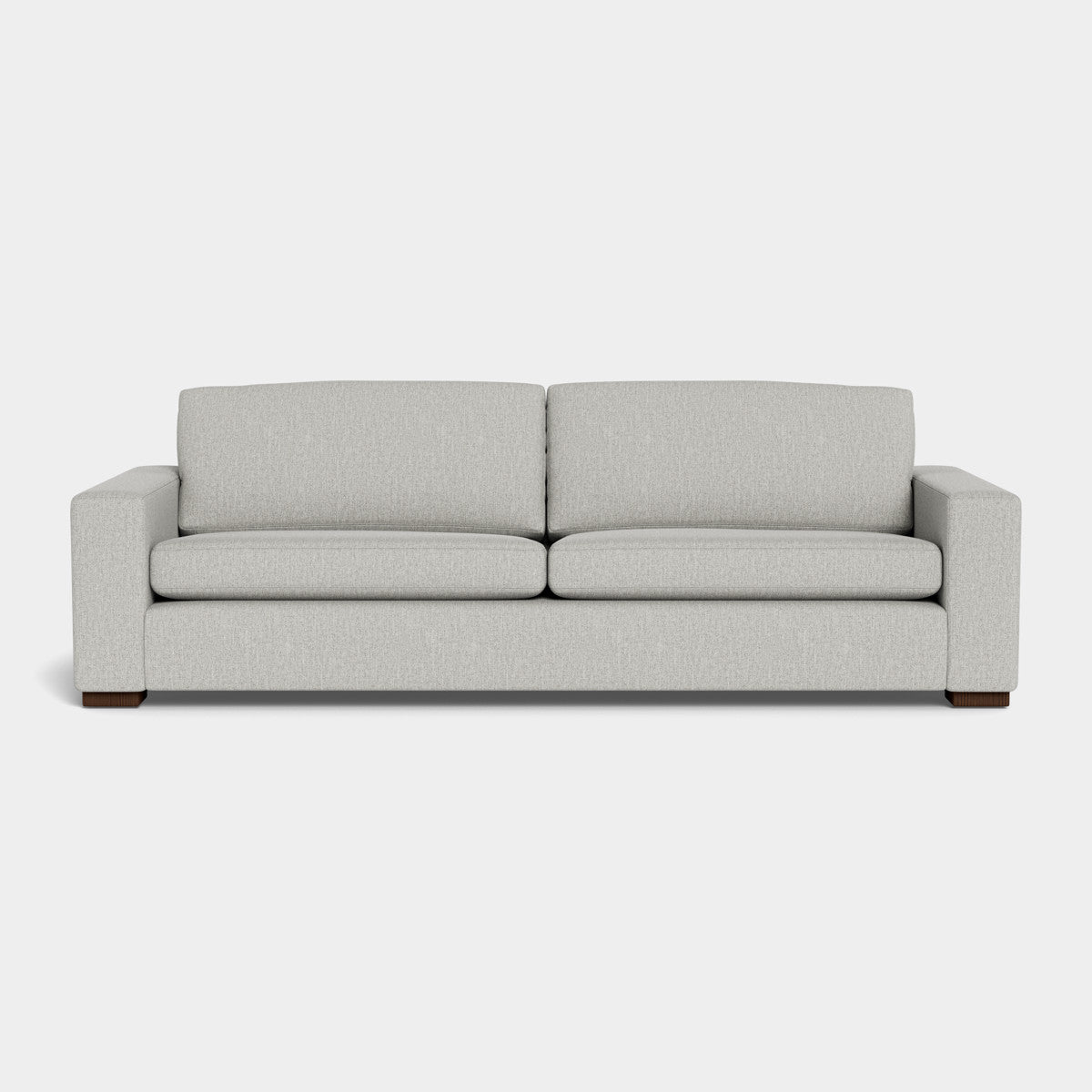 The Barton Sofa features a modern, minimalist design with light gray upholstery and straight lines, set against a plain white backdrop. It includes two seat cushions and two back cushions, complemented by square armrests and dark wooden legs.