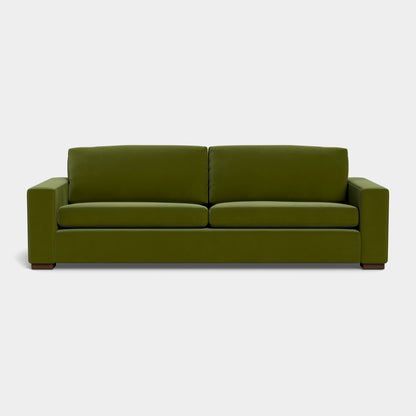 The Barton Sofa features a minimalist design with clean lines and square armrests, displayed against a plain white background. It includes two seat cushions and two back cushions, offering a contemporary look in modern green.