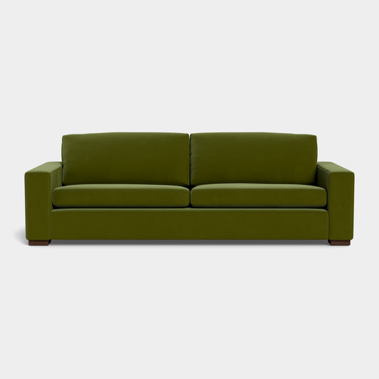 The Barton Sofa features a minimalist design with clean lines and square armrests, displayed against a plain white background. It includes two seat cushions and two back cushions, offering a contemporary look in modern green.