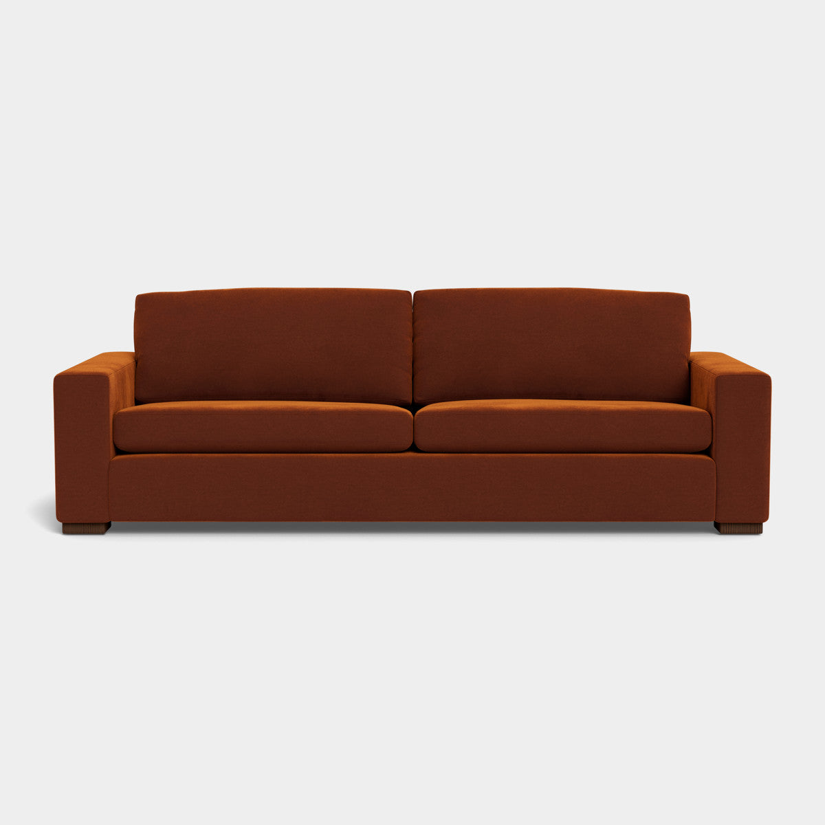 The Barton Sofa features a minimalist and stylish design with its modern brown upholstery, clean lines, and square armrests set against a light gray background. It includes two seat cushions and two back cushions.