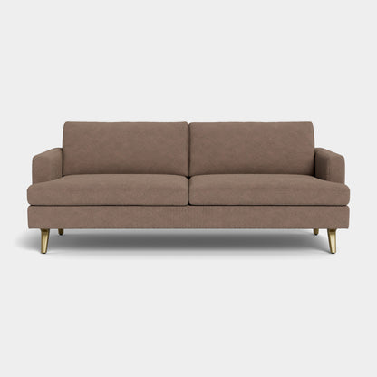 A Lido Sofa, featuring a brown mid-century modern design with straight arms and tapered brass legs, is set against a plain white background. It includes two seat cushions and two back cushions.