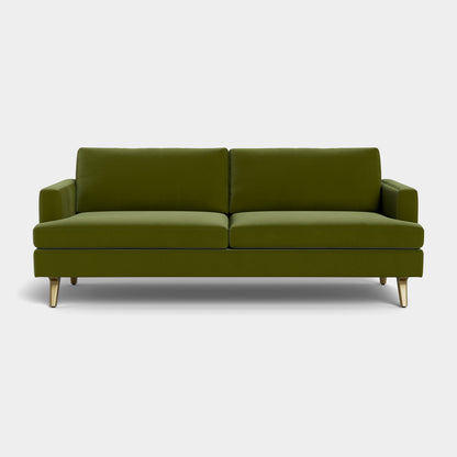 The Lido Sofa, a contemporary piece in green, features two seat cushions, two back cushions, and elegant brass legs, all showcased against a simple white background.