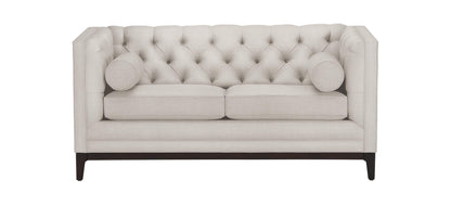 Introducing the Anderson Loveseat, a cream-colored, tufted piece with two matching round cushions. This loveseat is designed with a high back and arms and is supported by wooden legs.