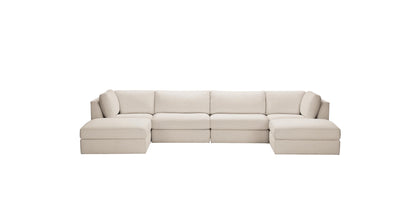 The Daydreamer Modular Six-Piece Sectional is a beige sofa with clean lines and plush cushions, comprising multiple sections including left and right armrests and a central wedge, set against a plain white background.