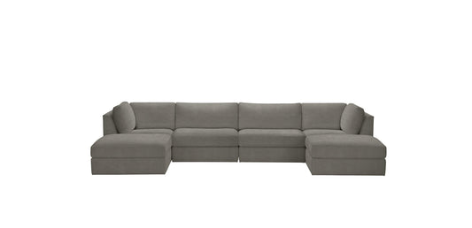 The Daydreamer Modular Six-Piece Sectional is a gray, L-shaped sofa featuring thick cushions and a minimalist design set against a white background.