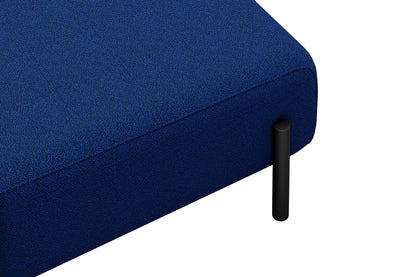 A detailed view of the Palo 2-seater Sofa's blue textured corner, featuring a black cylindrical metal leg. The fabric showcases a coarse, speckled pattern. The image emphasizes the lower section of the sofa, highlighting its modern, minimalist design.