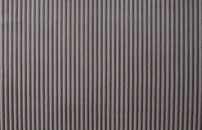 Close-up of a textured surface with vertical ridges in a soft, brown fabric, resembling the Justine Corduroy Convertible Sleeper Loveseat. The ridges cast a pattern of shadows and highlights, enhancing depth and visual interest in the monochromatic design.