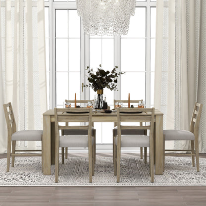 A dining room features a Wooden Dining Table Set with an extendable light wood table for four, adorned with candles and floral centerpiece. Four dining chairs have light gray cushions. Large windows are framed by white curtains, a chic chandelier hangs above, and a patterned rug lies underneath.