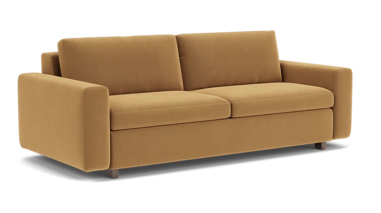 Introducing the Reva Storage Sofa: This contemporary mustard-colored sofa features two seat cushions and two back cushions, complemented by wide armrests and supported by four short, dark wooden legs. Its design is both minimalist and elegant.