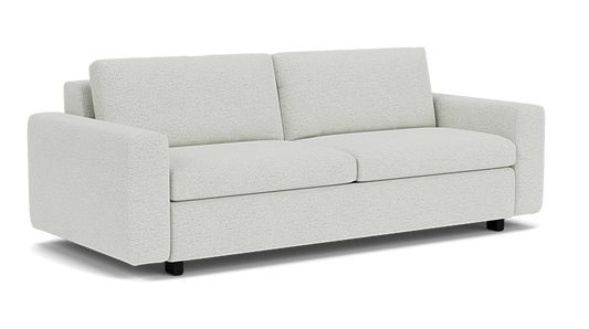 The Reva Storage Sofa is a light gray piece featuring two seat cushions and two back cushions. It has straight armrests and is set against a plain, dark background.