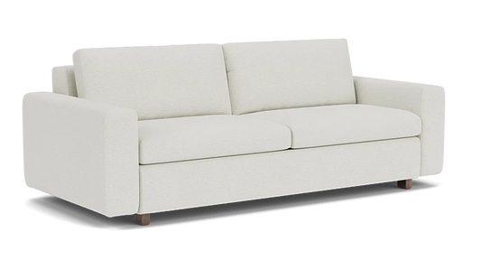 Introducing the Reva Storage Sofa: a contemporary cream-colored sofa featuring two cushions and straight armrests, elegantly set against a simple black background. It boasts a minimalist design with short, dark wooden legs.