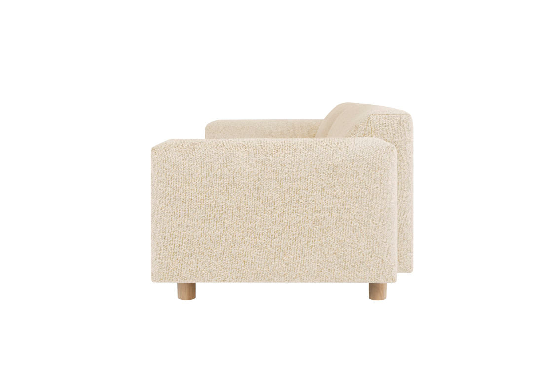 Side view of the minimalist Koti 3-seater Sofa featuring textured beige fabric and wooden legs, set against a white background.