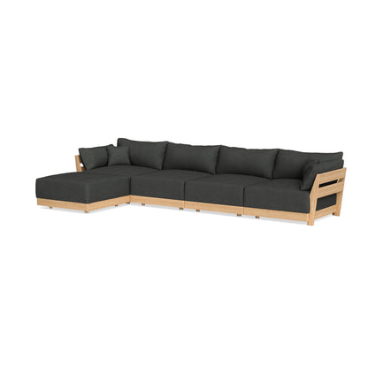 The Modular Bondi Latte 4 Seater Sectional is a sizable, contemporary sofa with dark green fabric upholstery and a light wooden frame. It includes a left-side chaise lounge, providing ample seating for any living room.