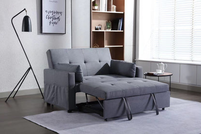 A modern living room with a gray 2 Seaters Sleeper Sofa Bed Linen Fabric 3-In-1 Convertible Loveseat featuring a side pocket, standing lamp, side table with teapot and cup, bookshelf with decor, and wall art. A large window on the right has blinds drawn halfway.