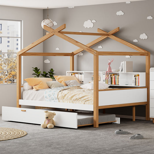 A cozy children's room showcases a Twin Size Wooden House Bed with an original wood frame, white bedding, twin trundle, and bookshelf storage. Cloud decals decorate the gray wall. Above the bed on a shelf sit a pink rabbit figurine and plant with a teddy bear on the trundle drawer.