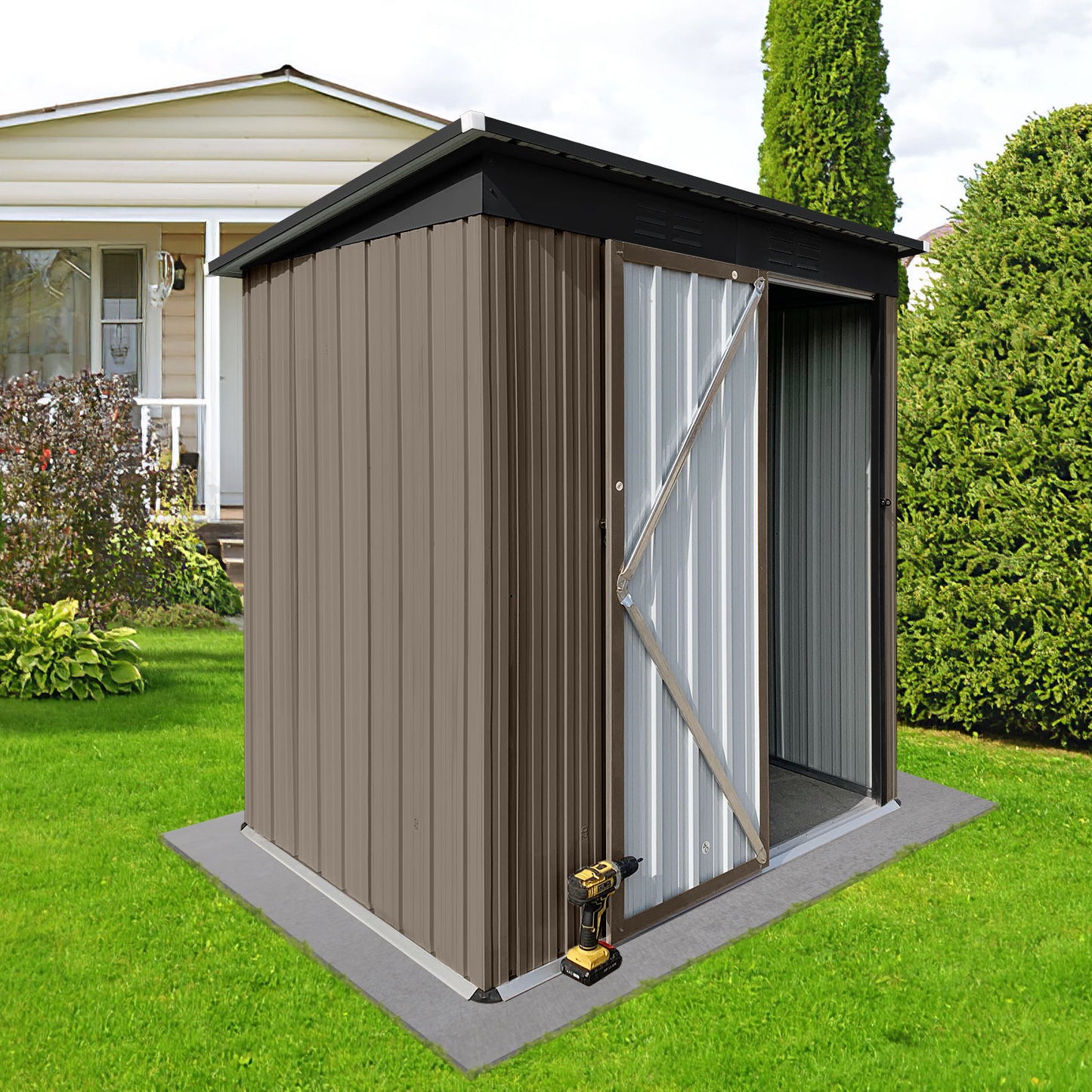 A 5x4 ft Garden Shed, brown and metal, with an open doorway and empty interior is on a concrete pad in a grassy backyard. A drill lies at the base, while a house with a porch is seen in the background among bushes and trees.