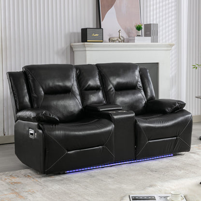 The modern living room features a 2 Seater Home Theater Recliner with black leather, armrests, two cup holders, a storage box, and blue LED lighting at the base. The setting includes light-colored walls, a painting, and decorative items on a mantle in the background.