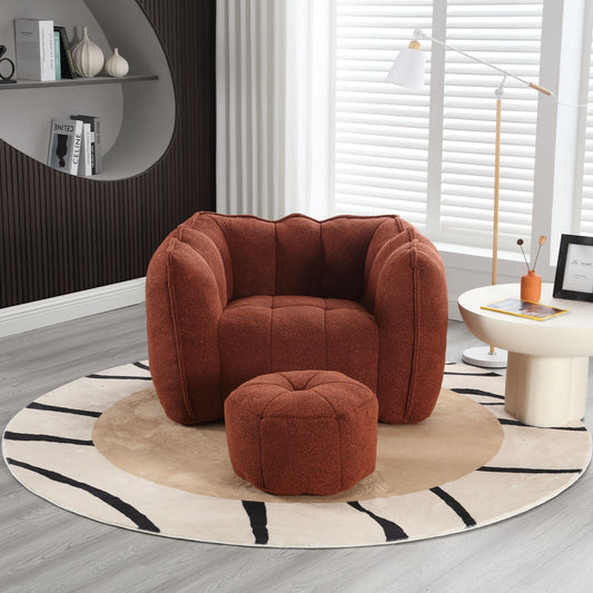 A soft bean bag chair with high resilient foam sits on a circular rug alongside a matching ottoman. The room includes a floor lamp, side table with a framed picture, and a bookcase filled with books. White blinds cover the windows against dark walls highlighted by vertical lines.