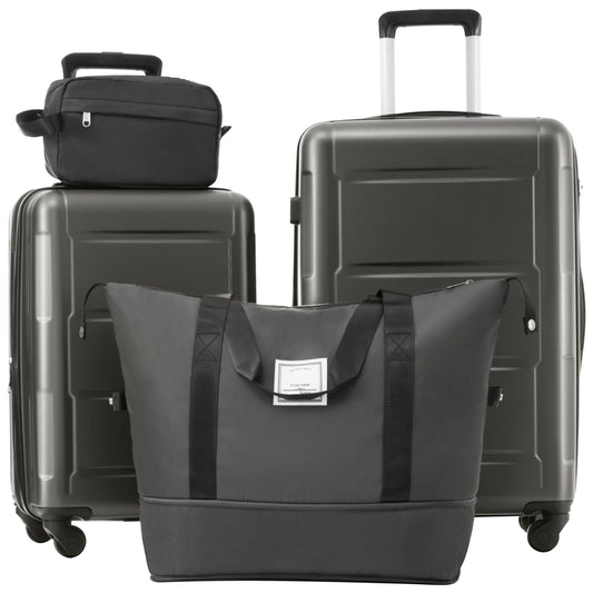 This dark grey and black luggage set includes two expandable spinner suitcases with TSA locks (20"/24"), both featuring wheels and retractable handles, plus a large tote bag and small toiletry bag. The smaller upright suitcase is positioned on the left.