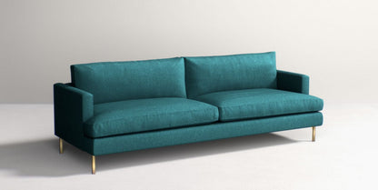 The Bowen 91" Sofa, in a modern teal color and featuring clean lines with plush cushions, is set against a plain background. Its slim, gold-colored legs provide an elegant touch to its contemporary design.