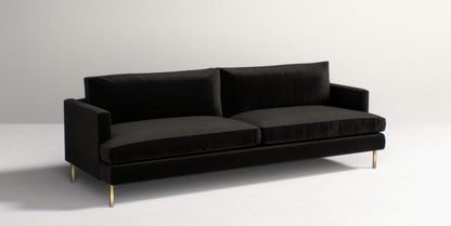 The Bowen 91" Sofa, a modern black piece with a sleek design, features two large cushions and slim gold legs, set against a plain white backdrop.