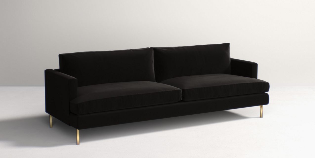 The Bowen 91" Sofa, featuring a sleek and modern black design with two cushions and slender gold legs, is placed on a light grey background.