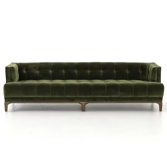 Dylan Sofa by Four Hands in green velvet, showcasing a tufted backrest and seat with a wooden base and tapered legs on a white background.