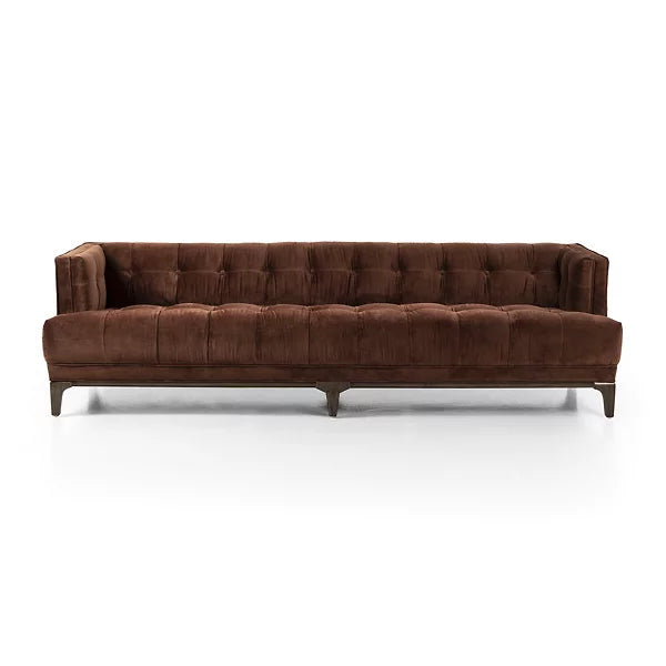 The Dylan Sofa by Four Hands features a modern design with a brown tufted finish, low back, and wooden legs, set against a white background.