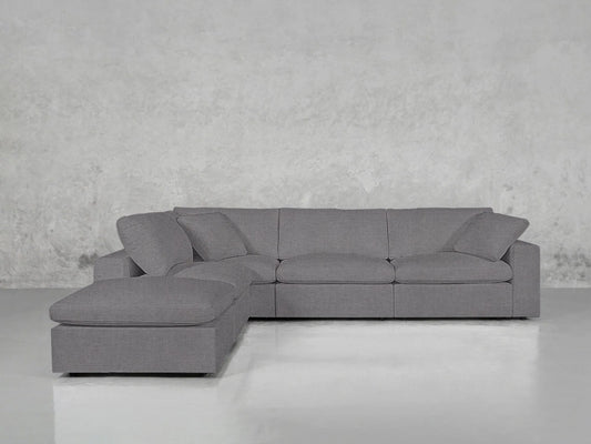 The 5-Seat Modular Corner Lounger Sectional, featuring a modern gray design with a left-facing chaise, is positioned against a textured gray wall. Its clean lines and minimalist aesthetic contribute to a sleek, contemporary look on the shiny gray floor.