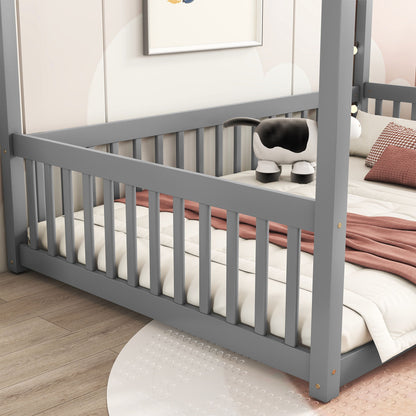 A Canopy Frame Floor Bed with Fence and Guardrails is shown. It features a white mattress, pink quilt, and a plush cow toy. The room has wooden flooring, a view of a round white mat, and a framed picture on the wall.