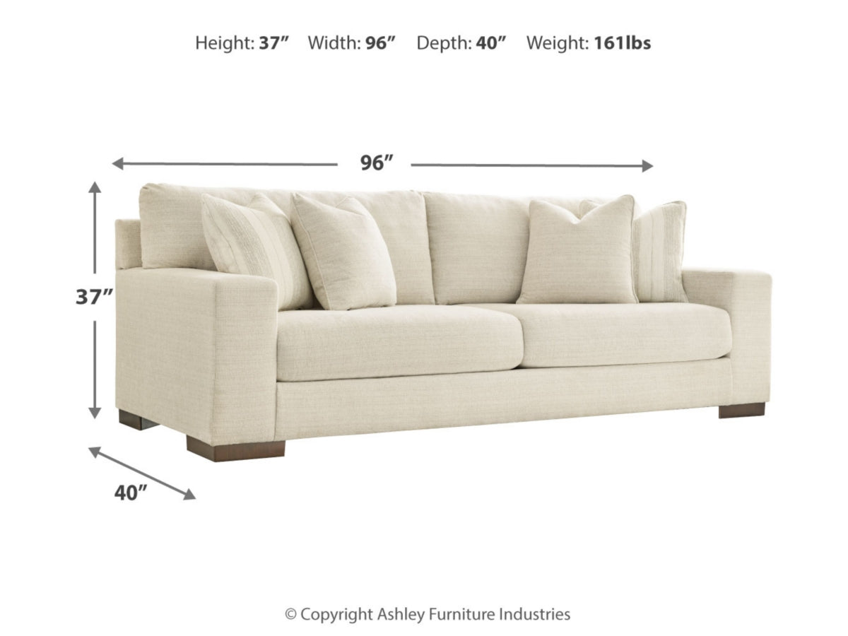 Image of a cream-colored Maggie Sofa with dimensions labeled: Height 37", Width 96", Depth 40". The sofa features plush cushions and two accent pillows. Weight is 161 lbs. Copyright Ashley Furniture Industries.